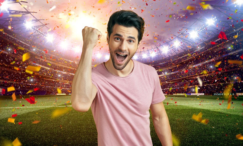 A fan celebrating in a packed stadium